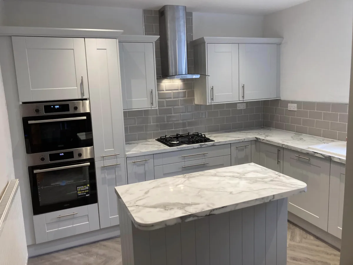 Newly fitted grey kitchen with marble island