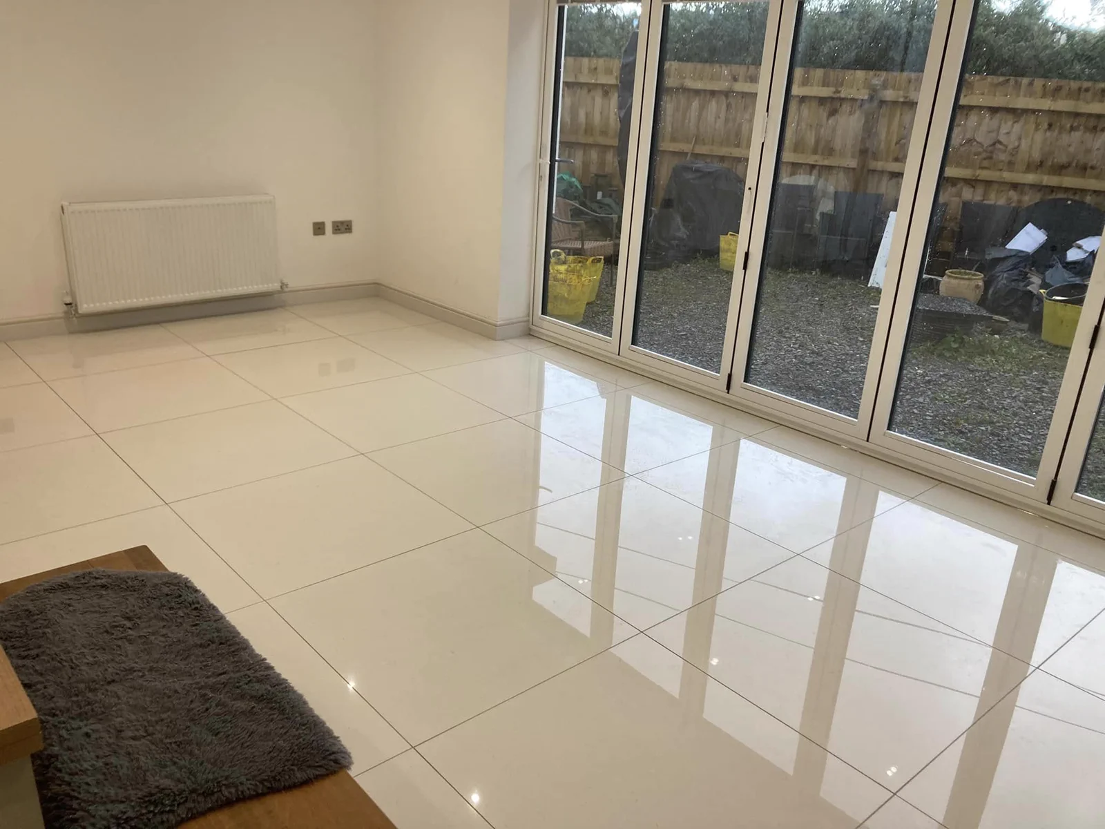 Freshly finished tiled family room with patio doors